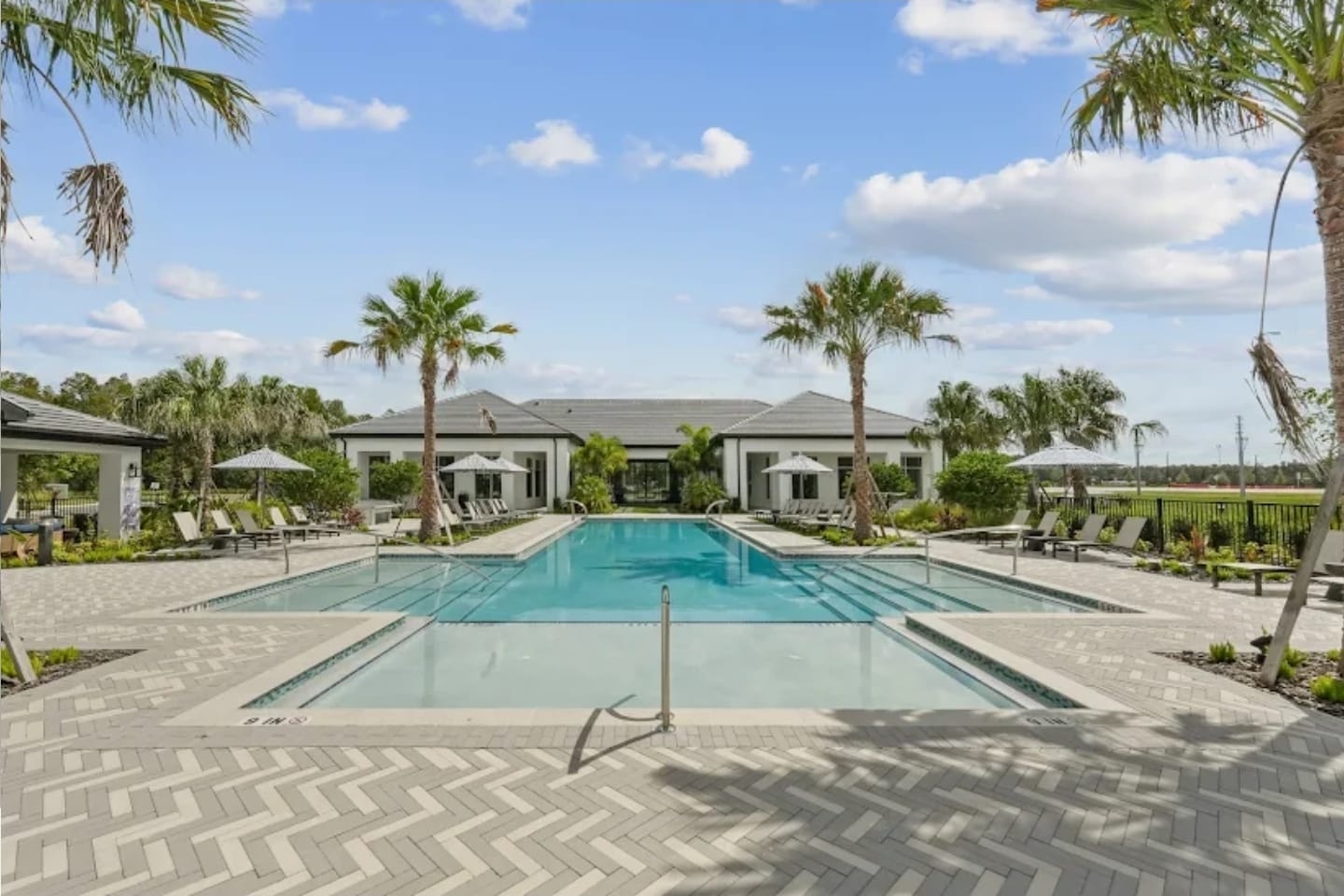 Paver installation around a resort-style pool deck